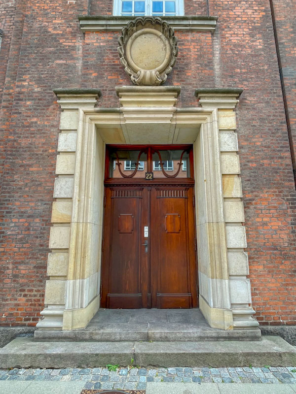 Austere corporate door, Vester Farimagsgade, Copenhagen, Denmark, September 2024