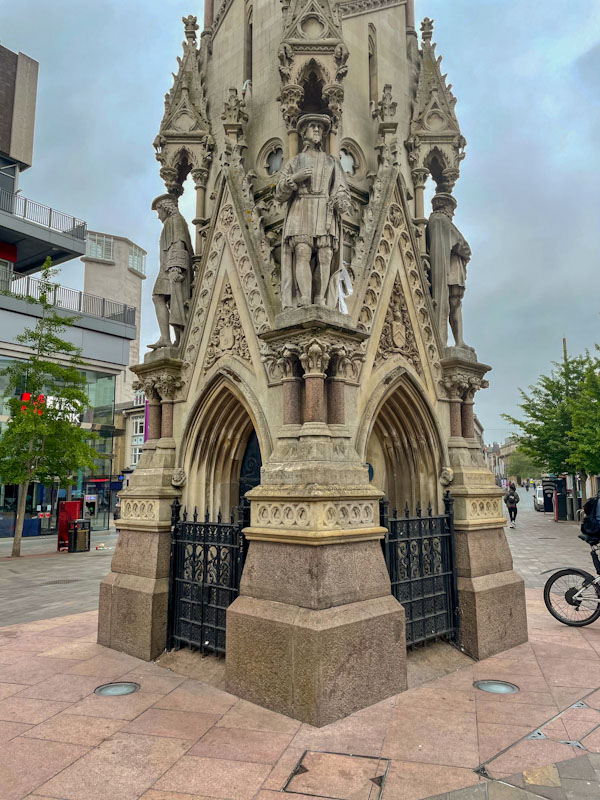 Haymarket memorial clock tower with gated arches, Leicester, May 2024