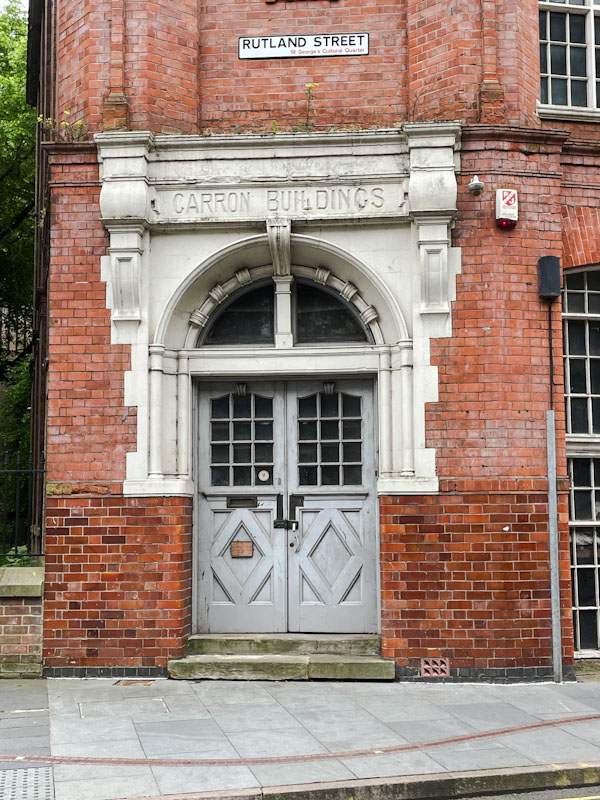 Grey door to the disused Carron Buildings, Rutland Street, Leicester, Leicestershire, May 2024