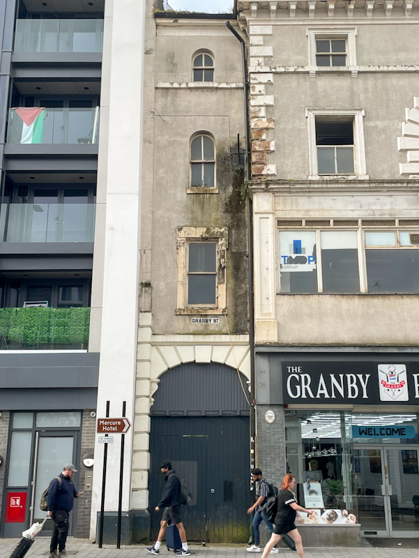 Ordinary door to the thinnest of buildings, Leicester, Leicestershire, May 2024