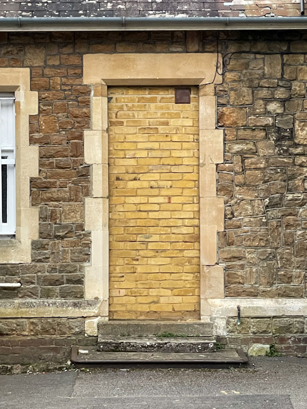 Ghost door on the station building, Godalming, Surrey, March 2025
