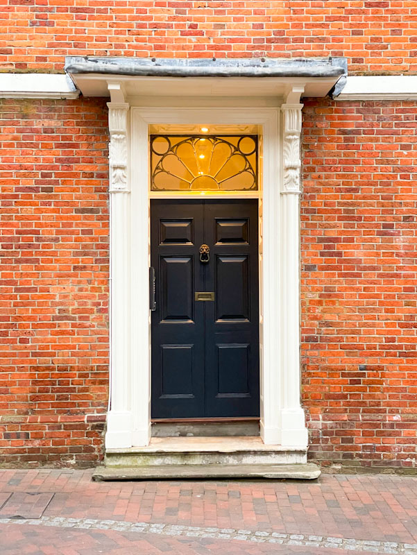Black door on High Street, Godalming, Surrey, March 2025