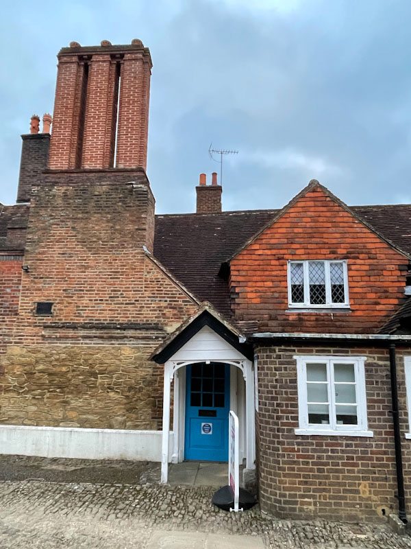 Blue door and high chimney stacks, Church Street, Godalming, March 2025