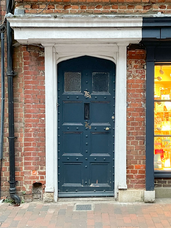 A classy old studded door, High Street, Godalming, March 2025