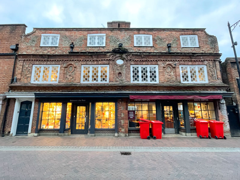 Shopfronts and doors in the early evening, but it is those windows that are really special, High Street, Godalming, March 2025