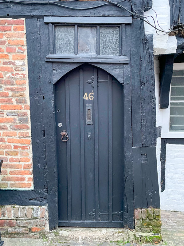 Wonky black door, High Street, Godalming, Surrey, March 2025