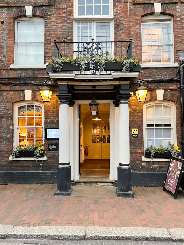 Grand entrance to The King's Arms and Royal Hotel, High Street, Godalming, Surrey, March 2025
