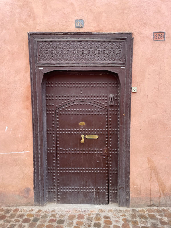 A studded door with two door knockers, Tariq Makhzen, Marrakesh, Morocco, January 2025