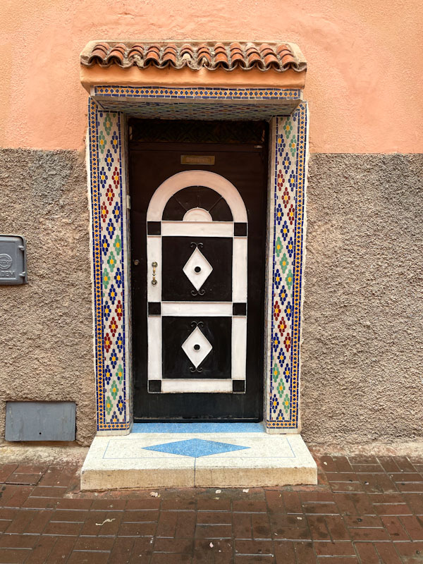 Elegant door with a stunning tile surround, Tariq Sahrij Gnaoua, Marrakesh, Morocco, January 2025