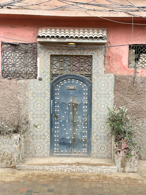 Studded patterned door and beautiful decorative tiles, Trik Tikhizrit, Marrakesh, Morocco, January 2025