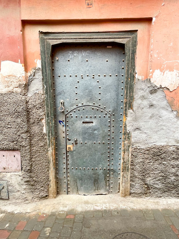 Studded metal door within a door, Derb Bougaldone, Marrakesh, Morocco, January 2025