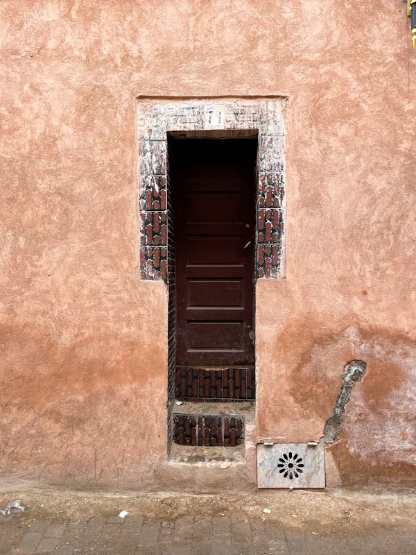 Steps up to a slim door, Rue Douar Graoua, Marrakesh, Morocco, January 2025