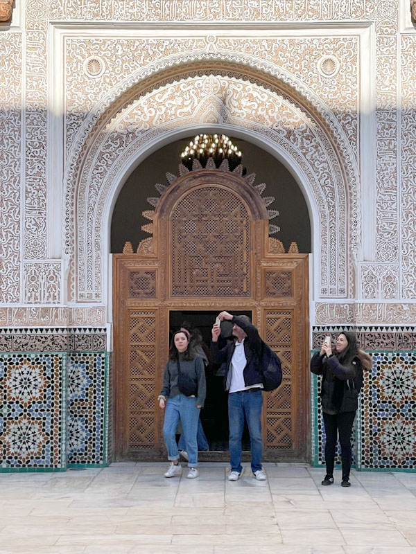 Doorway and wooden screen on one of the entrances to the courtyard, Madrassa Ben Youssef, Marrakesh, Morocco, January 2025