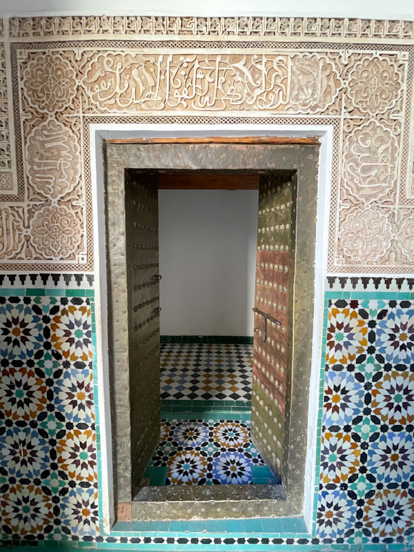 Door, tiles and plasterwork, Madrassa Ben Youssef, Marrakesh, Morocco, January 2025