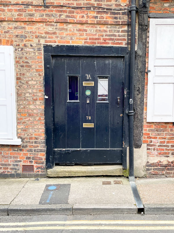 Wide black door, York, North Yorkshire, June 2024
