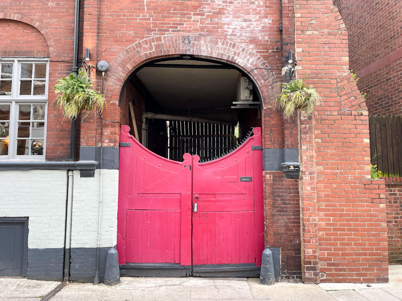 Pink gates and archway, York, North Yorkshire, June 2024