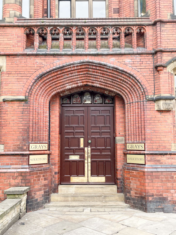 Stunning brick entrance and solid wooden doors of Grays Solicitors, York, North Yorkshire, June 2024