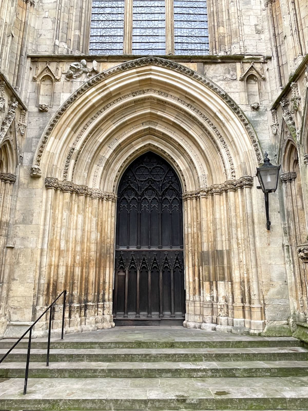 Right-hand door on the west front of York Minster, York, North Yorkshire, June 2024