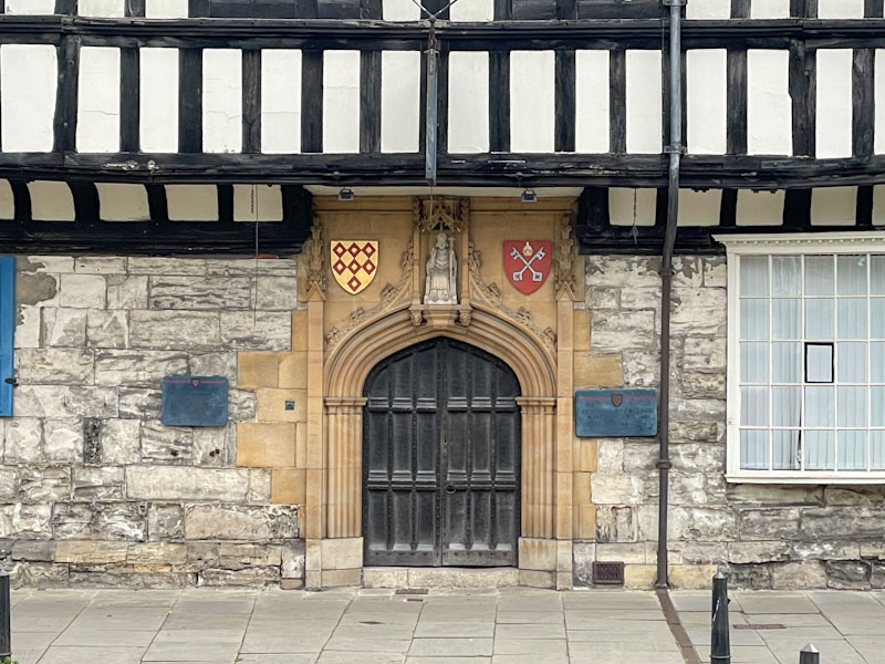 Panelled archway door to St William's College, College street, York, North Yorkshire, June 2024