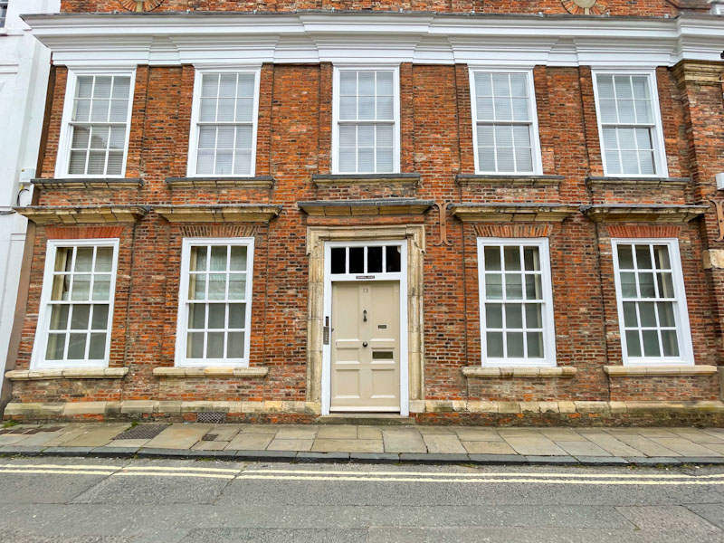 Stunning brick house with cream door, York, North Yorkshire, June 2024