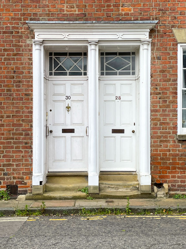 Pair of white panelled doors, spot the differences, York, North Yorkshire, June 2024