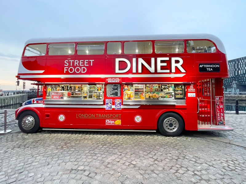 Open doorway to an old London bus repurposed as a mobile food outlet, Liverpool, March 2025
