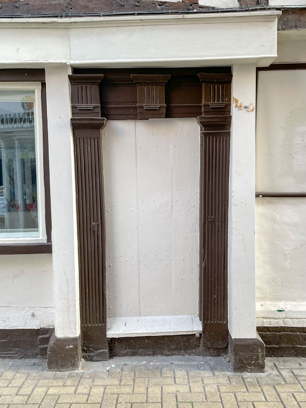 White door without door furniture, perhaps it isn't used any more, Hill's Lane, Shrewsbury, Shropshire, England, April 2025