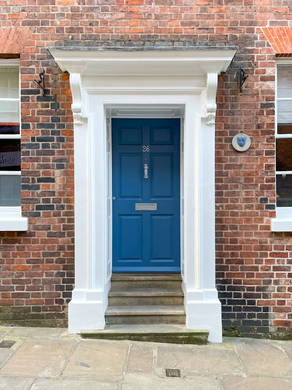 Formal blue door on with a small plaque that reads 'a building of special architectural or historic interest', Claremont Hill, Shrewsbury, Shropshire, April 2025