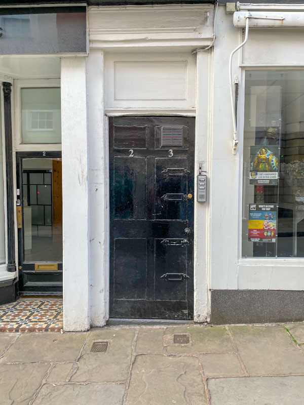 Black door to flats 2 and 3 with four letterboxes, Market Street, Shrewsbury, Shropshire, April 2025