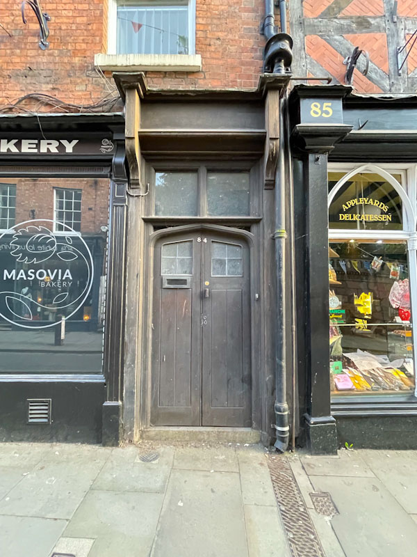 Inconspicuous old brown door and doorframe, Wyle Cop, Shrewsbury, Shropshire, England, April 2025