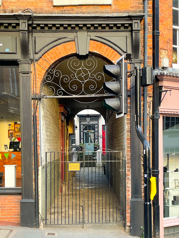 Door through passageway and gate, Dogpole, Shrewsbury, Shropshire, England, April 2025