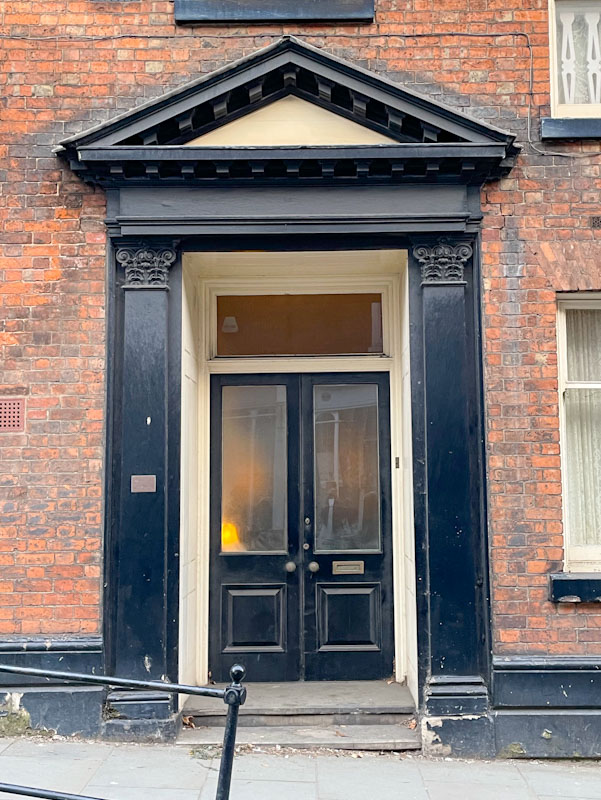 Double black doors and solid portico, Dogpole, Shrewsbury, Shropshire, England, April 2025
