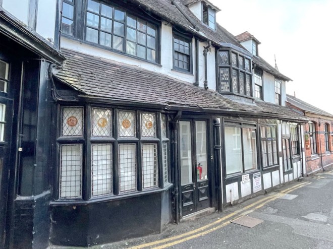 Black doors of a timber-framed building, Wyle Cop, Shrewsbury, Shropshire, England, April 2025