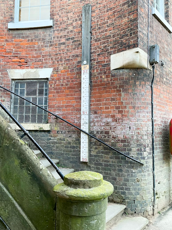Steps and a water gauge alongside the River Severn, Shrewsbury, Shropshire, England, April 2025