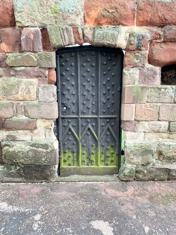 Studded door in the castle wall, Shrewsbury Castle, Shrewsbury, Shropshire, England, April 2025