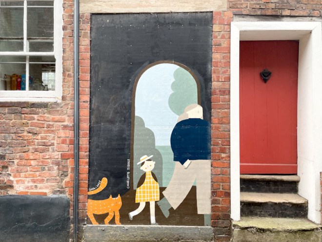 Red door and delightful mural depicting a passageway which was probably there and is now a ghost doorway, Belmont Bank, Shrewsbury, Shropshire, England, August 2025