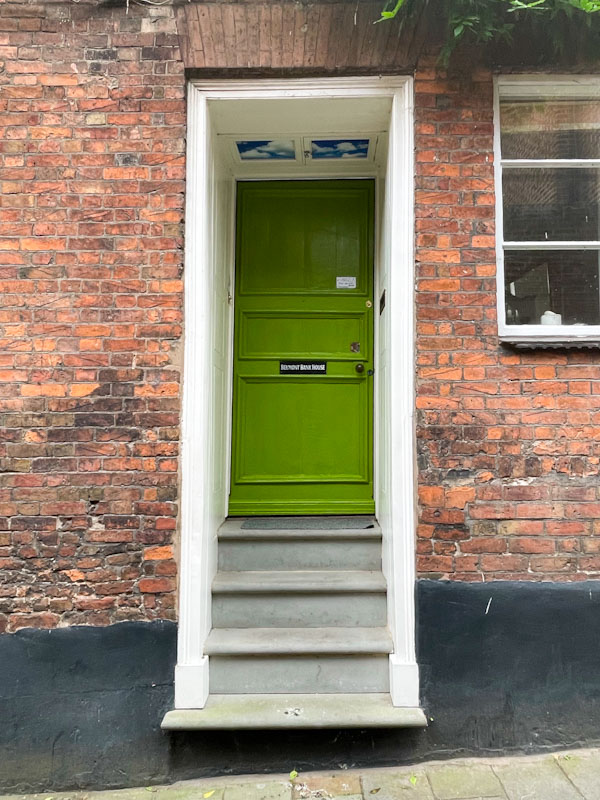 Steps up to a green door, Belmont Bank, Shrewsbury, Shropshire, England, August 2025