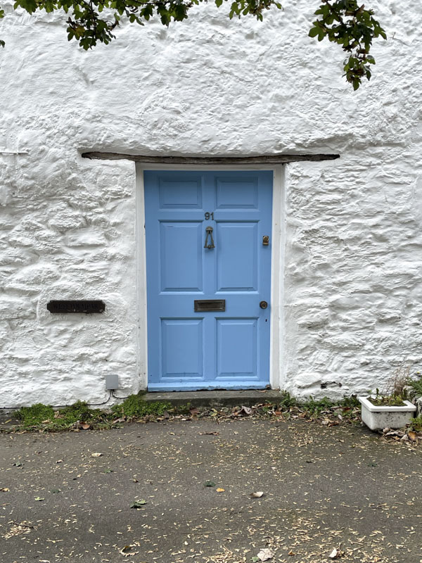 Classic blue short and wide Cornish Cottage door with lintel, Charlestown, Cornwall, October 2026