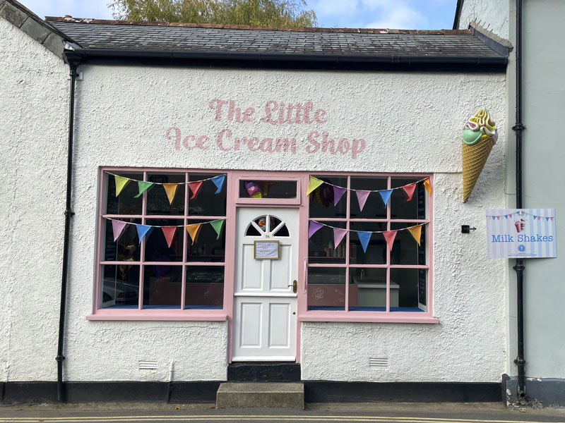 White door and pink woodwork at The Little Ice Cream Shop, The Parade, Lostwithiel, Cornwall, October 2026
