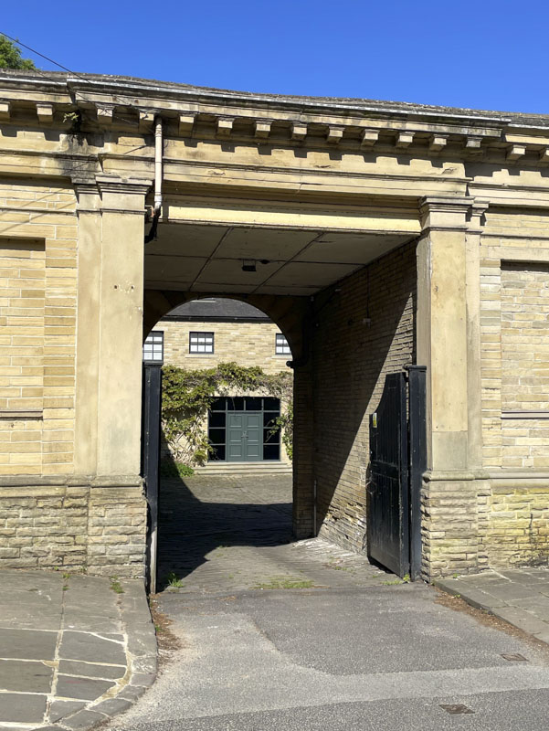 Gates archway and door, Victoria Road, Saltaire, West Yorkshire, England May 2025