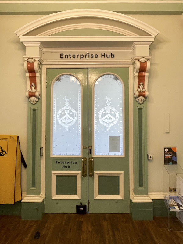 Inside doors in Victoria Hall, Victoria Road, Saltaire, West Yorkshire, England May 2025