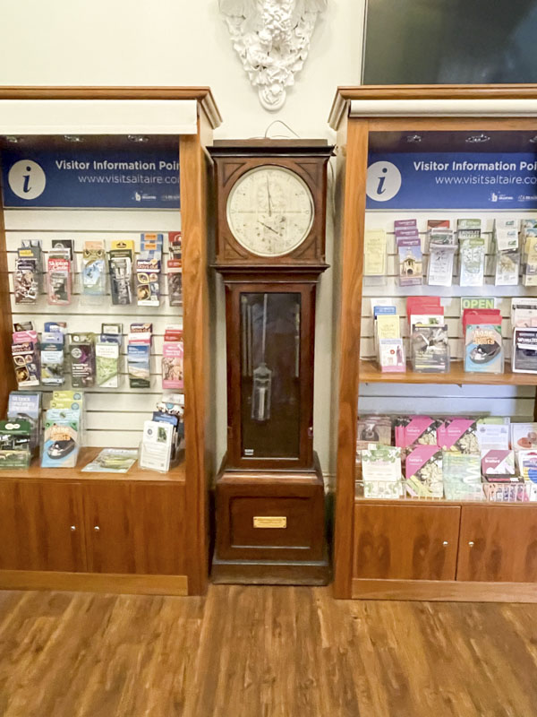 Grandfather clock and glass pendulum door, Victoria Hall, Victoria Road, Saltaire, West Yorkshire, England May 2025