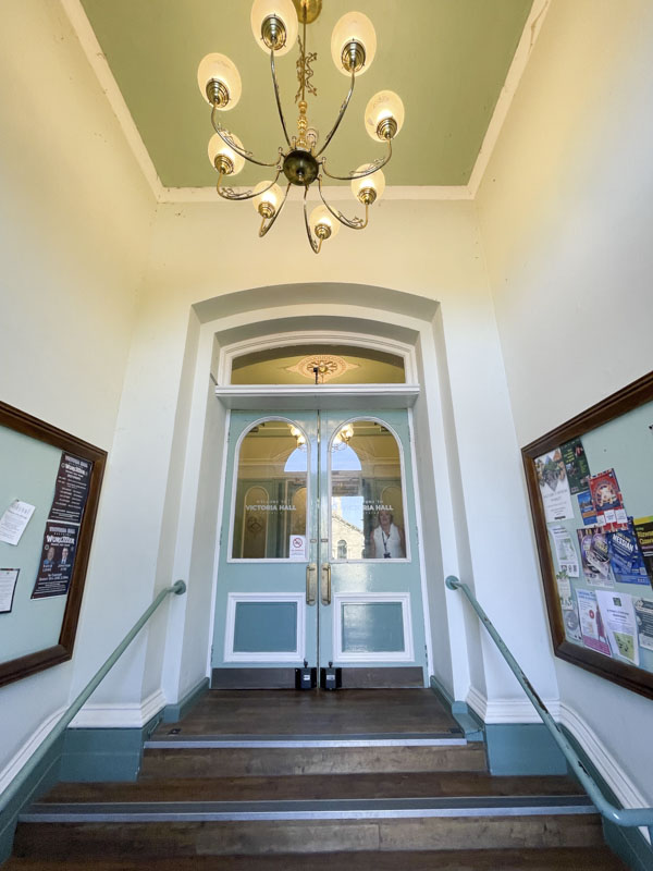 Inside doors in Victoria Hall, Victoria Road, Saltaire, West Yorkshire, England May 2025