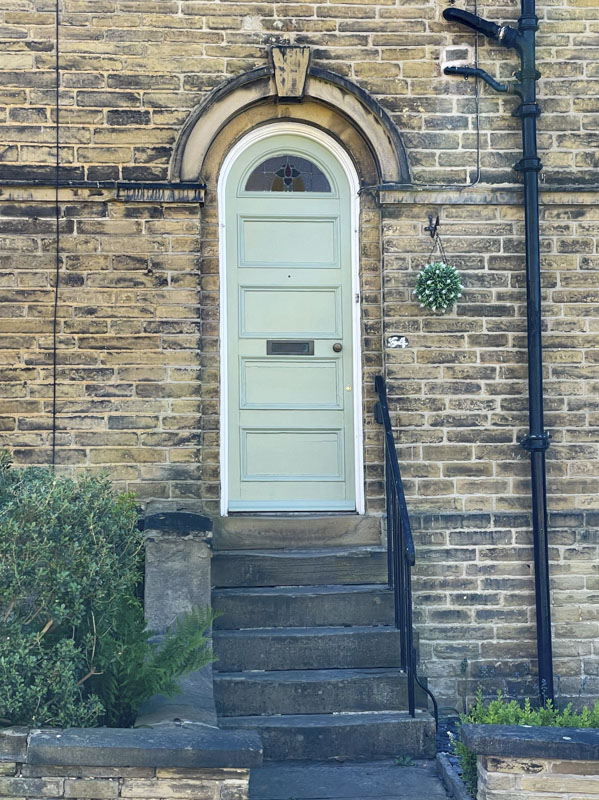 Mint green door, George Street, Saltaire, West Yorkshire, England, May 2025