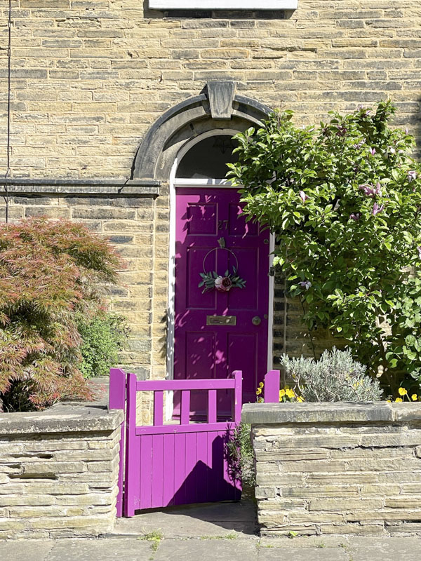 Pink door and gate, George Street, Saltaire, West Yorkshire, England, May 2025