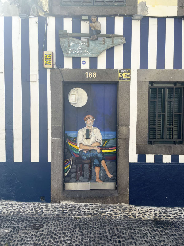 Door with a mural of a fisherman under the moon, Rua de Santa Maria, Funchal, Madeira, September 2025