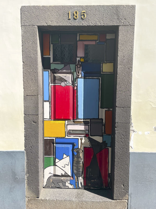 Door with a Mondrial-style painting with cartoon cats and dogs, Rua de Santa Maria, Funchal, Madeira, September 2025