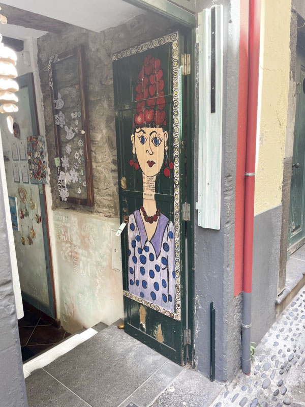 Open door with a portrait, Rua de SantaMaria, Funchal, Madeira, Portugal, September 2025