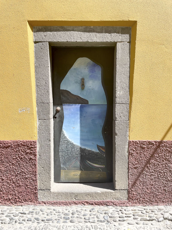 Door with a painting od a view from a cave, Rua do Barreiros, Funchal, Madeira, Portugal, September 2025